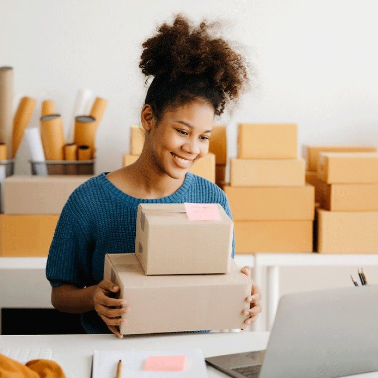 Smiling client preparing parcels for shipment